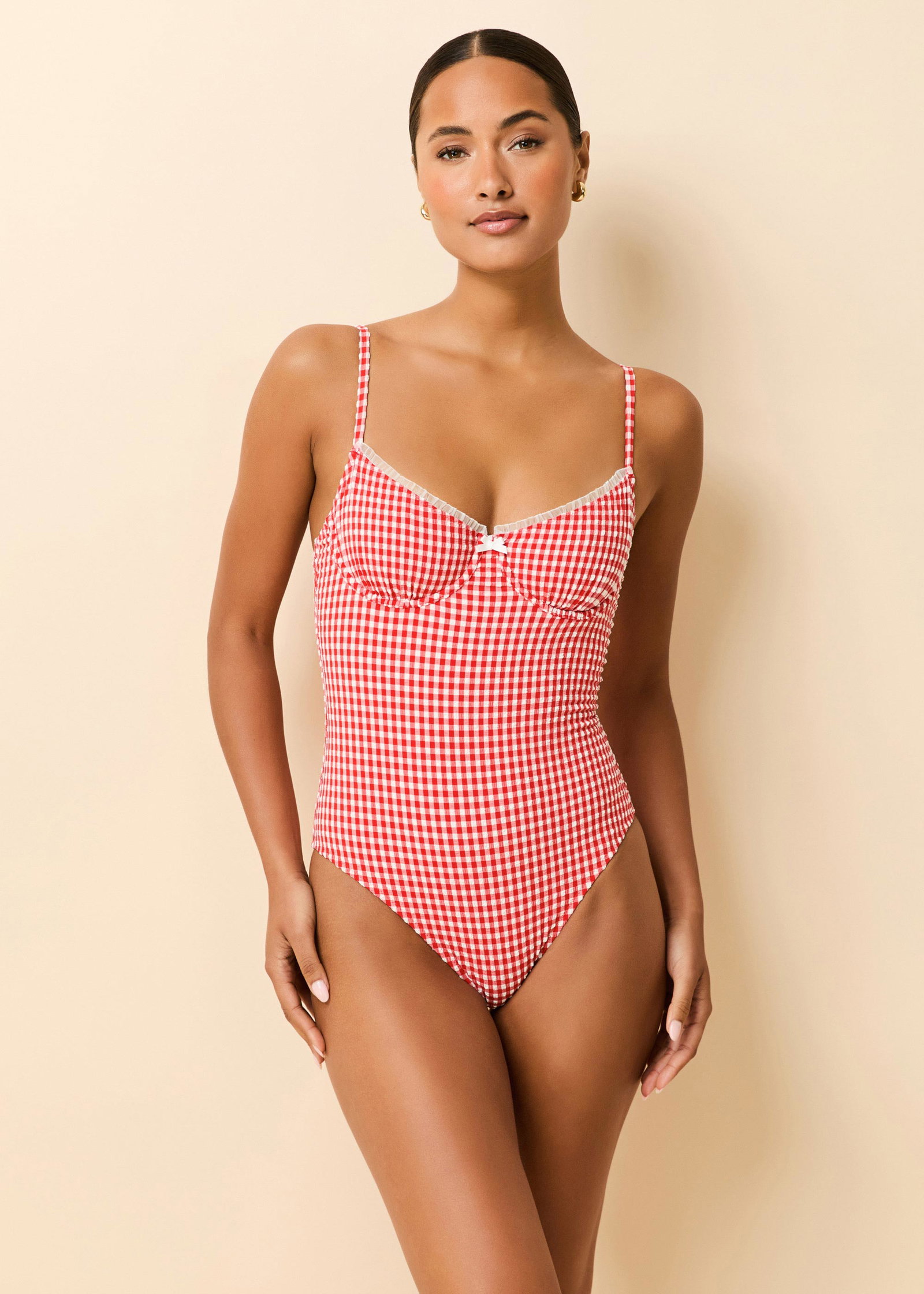 Woman in red gingham one piece swimsuit