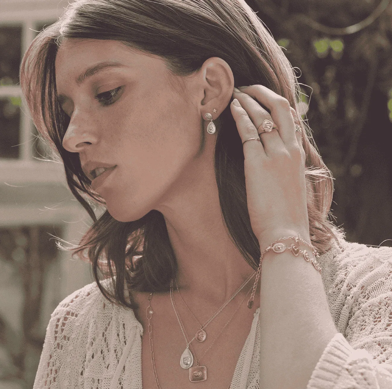 A model wearing silver and gold jewellery from the Sense of Nature collection by Alex Monroe