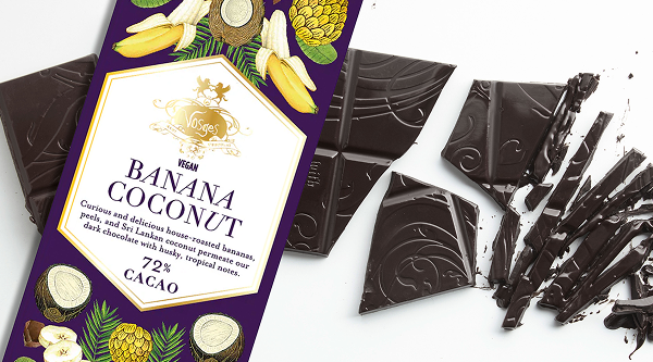 A Banana Coconut bar package sits atop the chopped dark chocolate