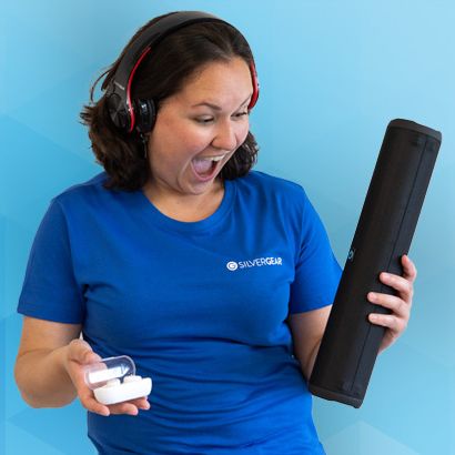 a woman is holding an audio box and headphones