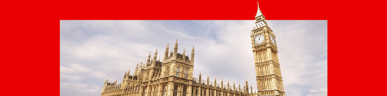 The Houses of Parliament on a red backdrop. The building is gold and the clock face of Big Ben is visible in front of a blue, cloudy skyline.