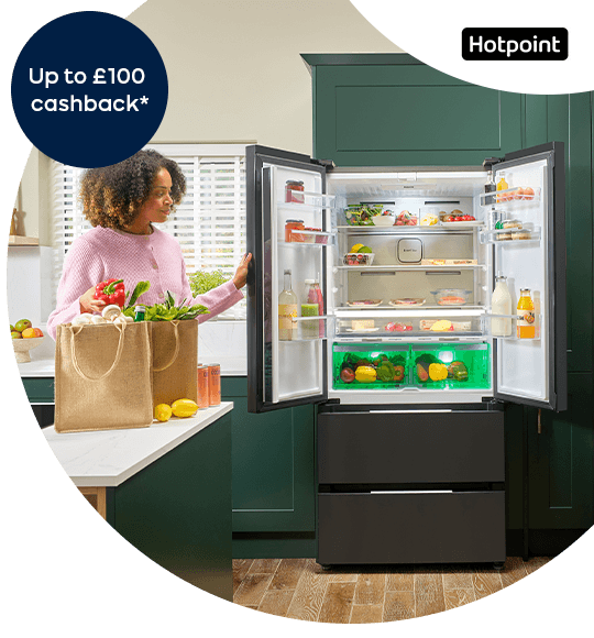 A woman opening a fridge freezer. 