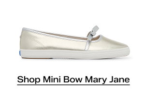 A side view of the Square Toe Mary Jane Leather Mini Bow in champagne/silver. Shop Now.