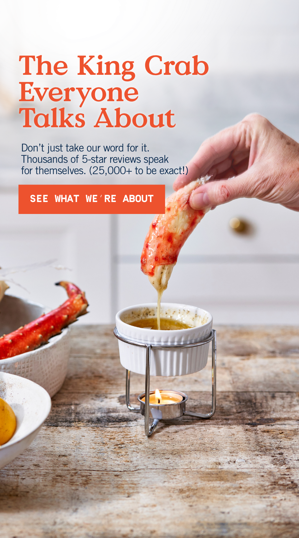 hand dipping king crab meat into butter.