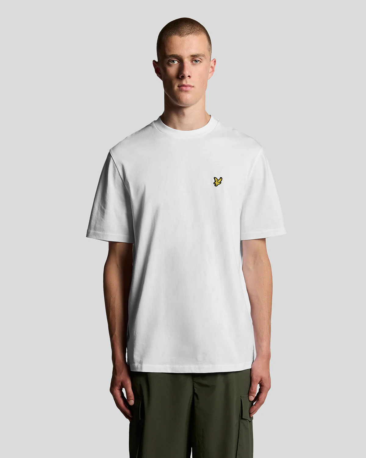 Model wears oversized crew neck t-shirt in white