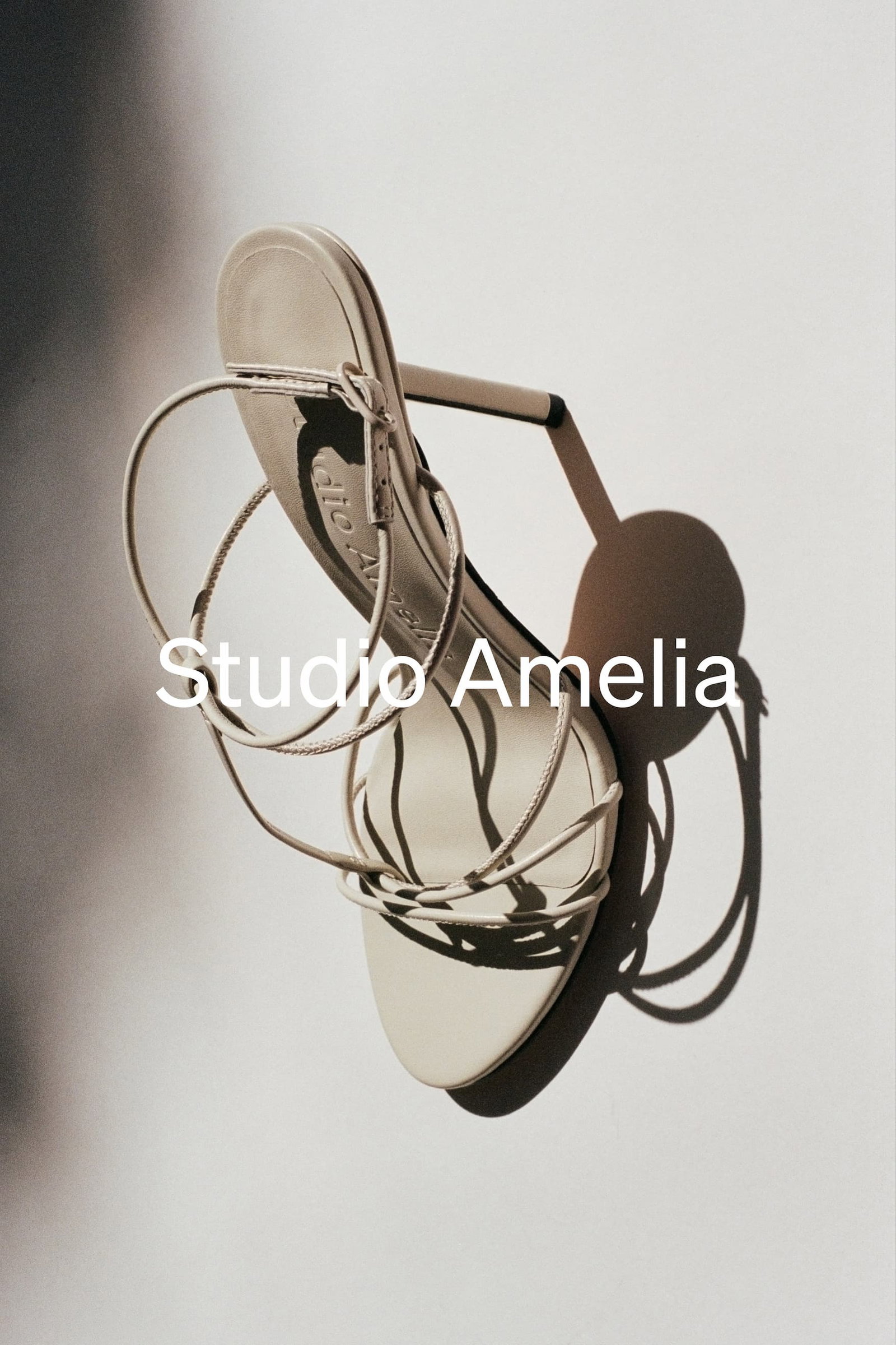 A white satin strappy sandal with diamante straps