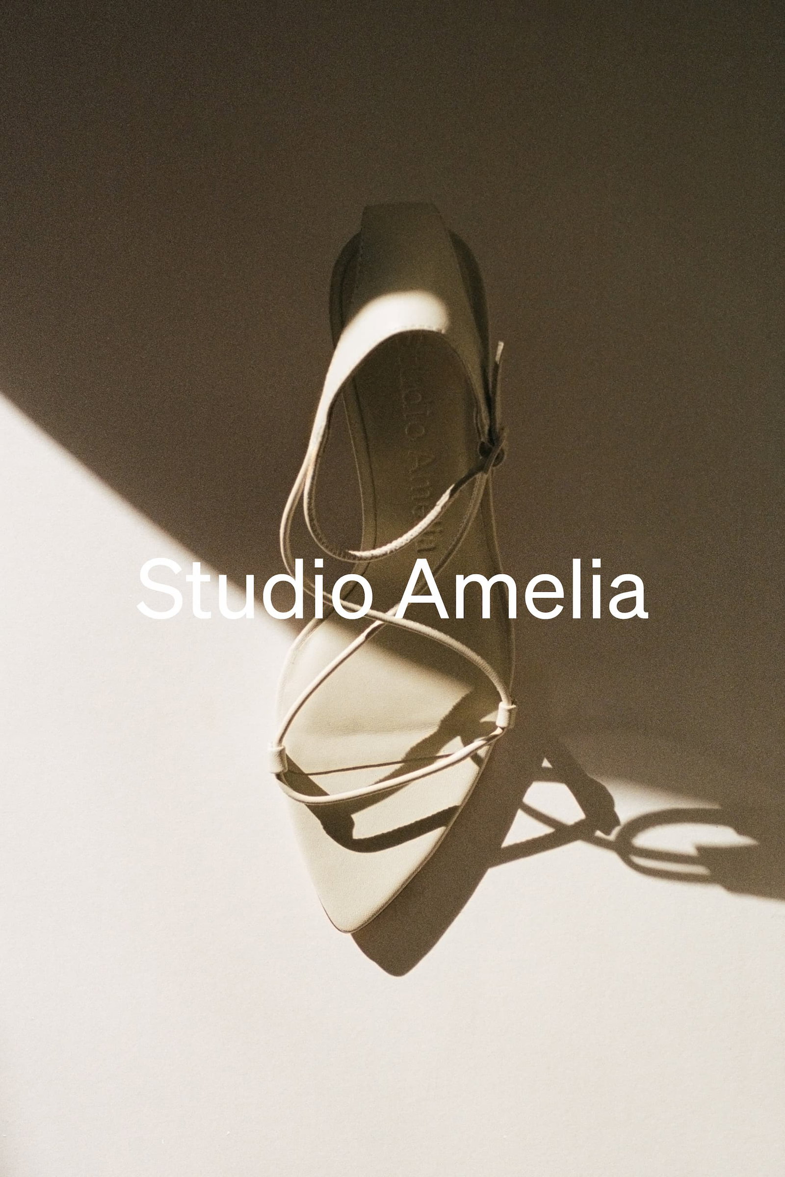 A white strappy sandal high heel with pointed toe