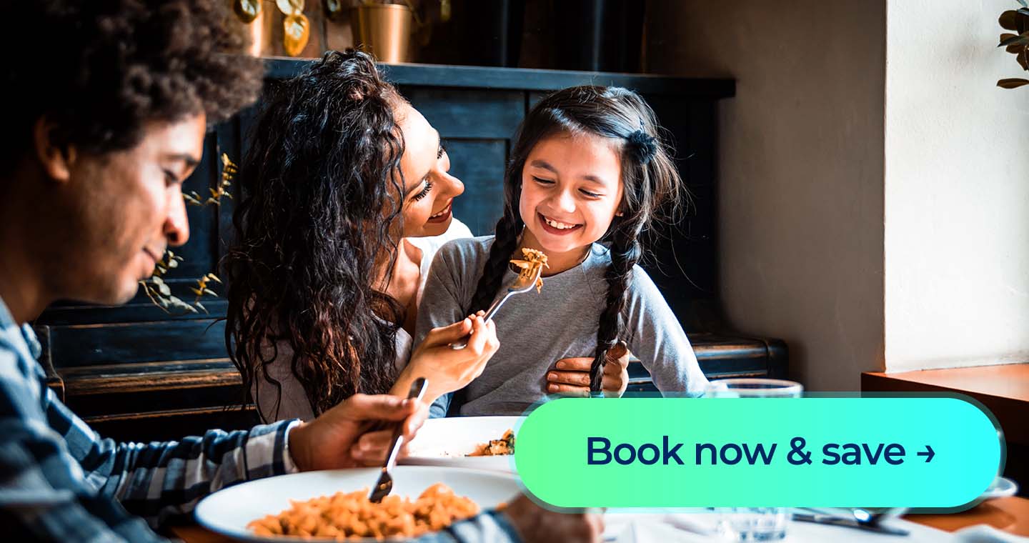 Smiling woman folds laundry beside a basket with a “Book now & save” button displayed.