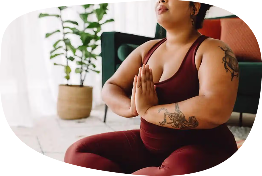 Image: Person sitting, doing yoga, with hands together