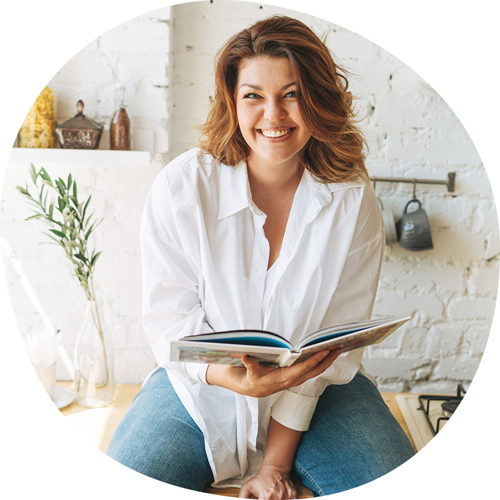 Image of a person smiling with a book