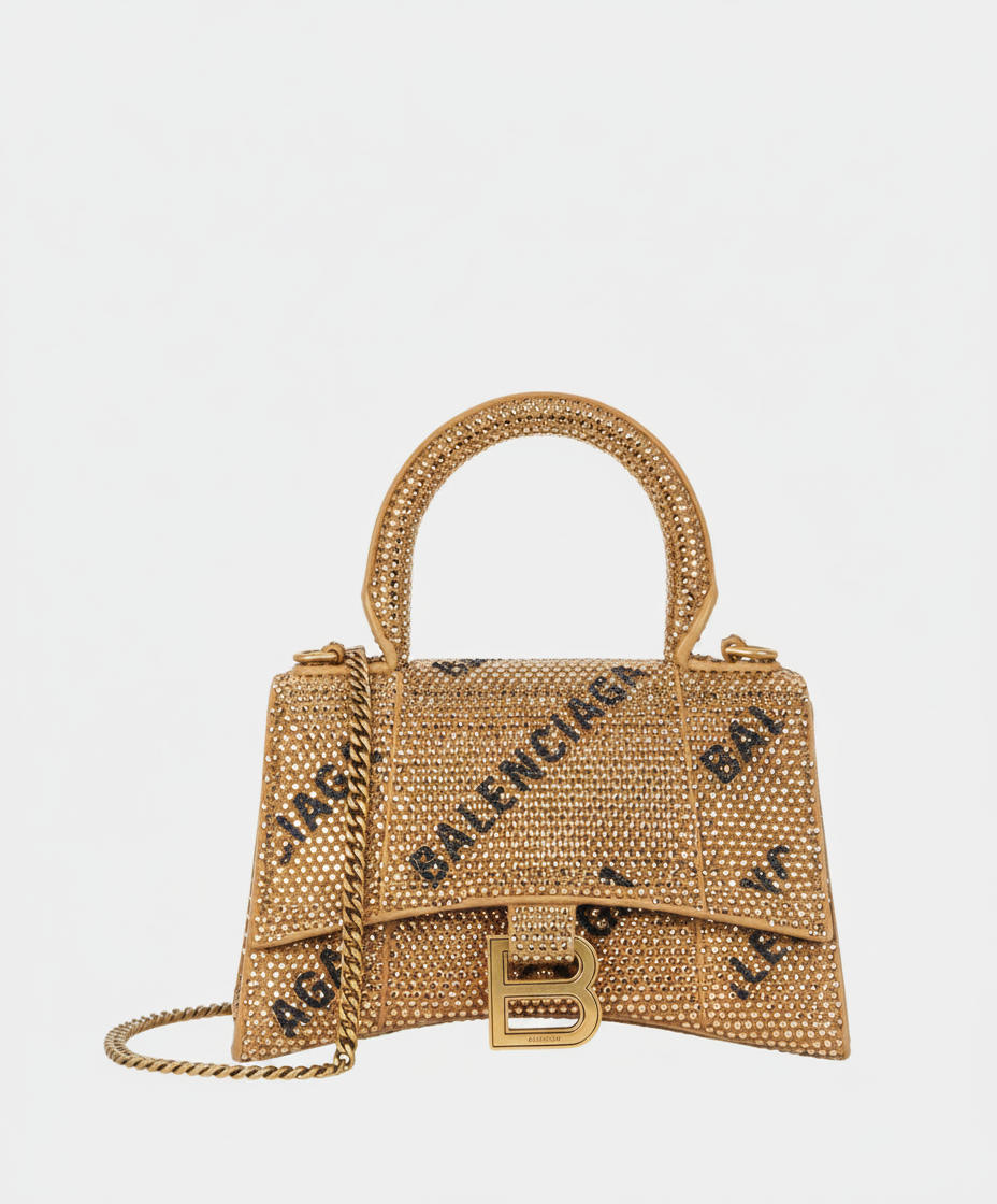 Gold Balenciaga Hourglass bag with rhinestones and black logo.