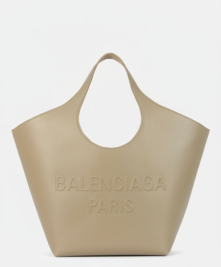 A beige Balenciaga Paris tote bag with embossed logo.