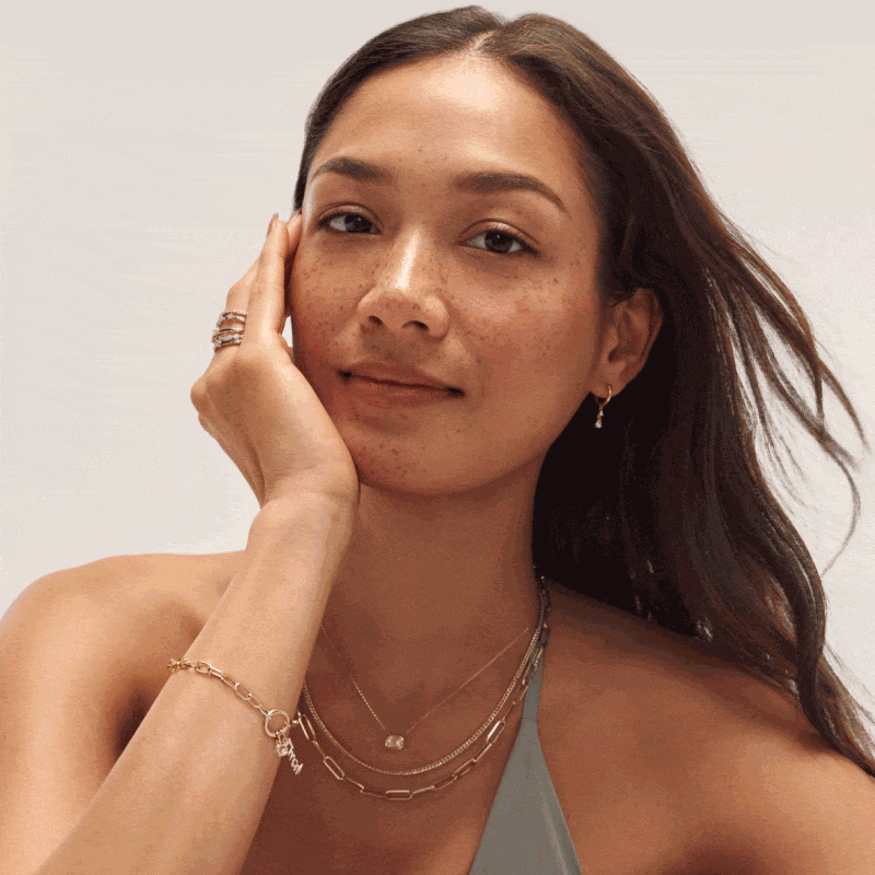 Two-frame GIF featuring a woman wearing fine yellow gold jewelry and a man wearing yellow a gold chain and yellow gold watch.