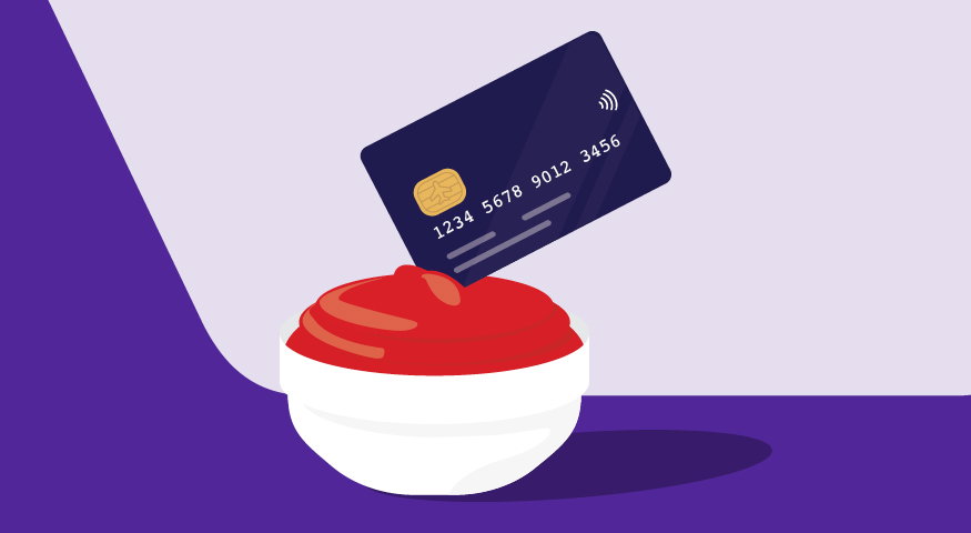 Credit card being dipped in a red sauce