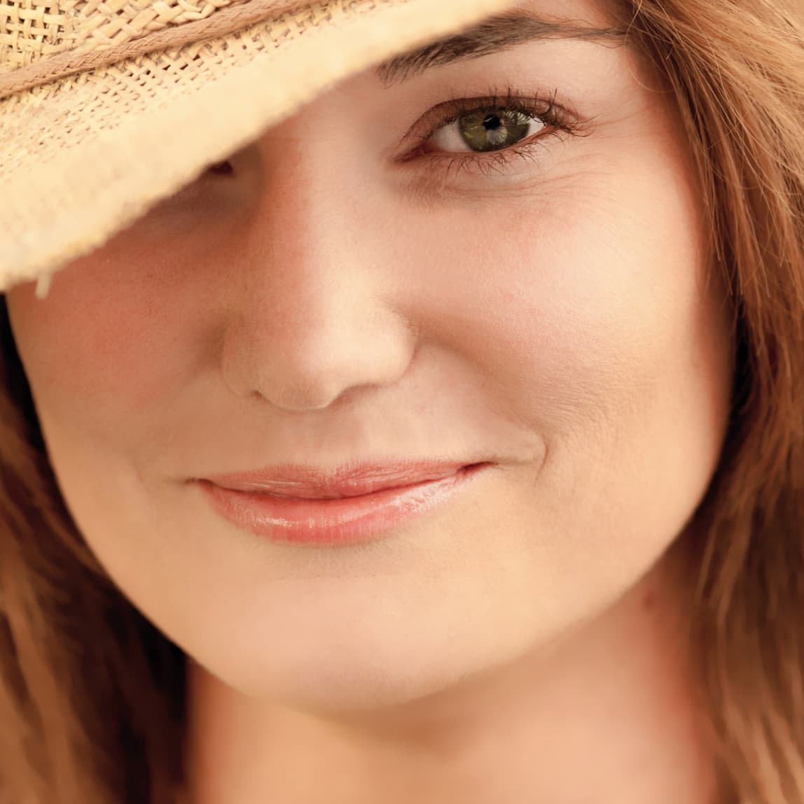 SPF myths - woman with hat