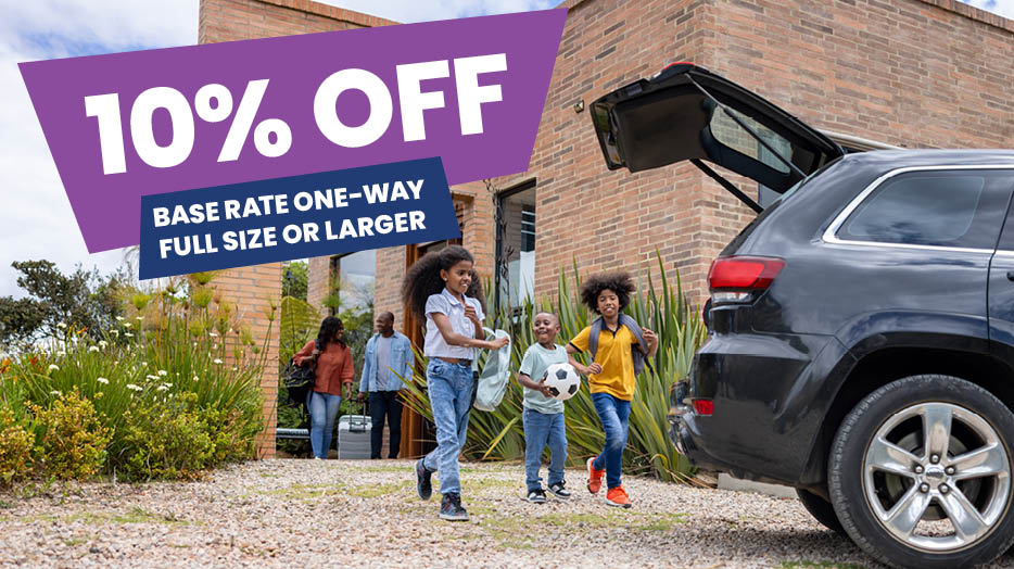 10% off base rate one-way full size or larger. A group of children loading luggage into the open trunk of an SUV.