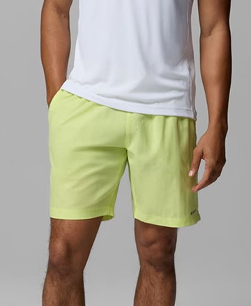 Waist-down image of a man wearing lime green shorts.