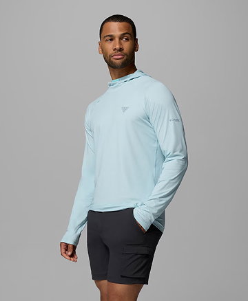 A man wearing a blue sun hoodie against a grey background.