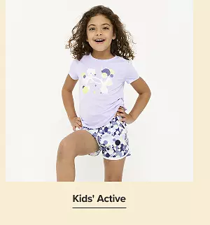Shop kids active. A girl wearing matching tee shirt and shorts.
