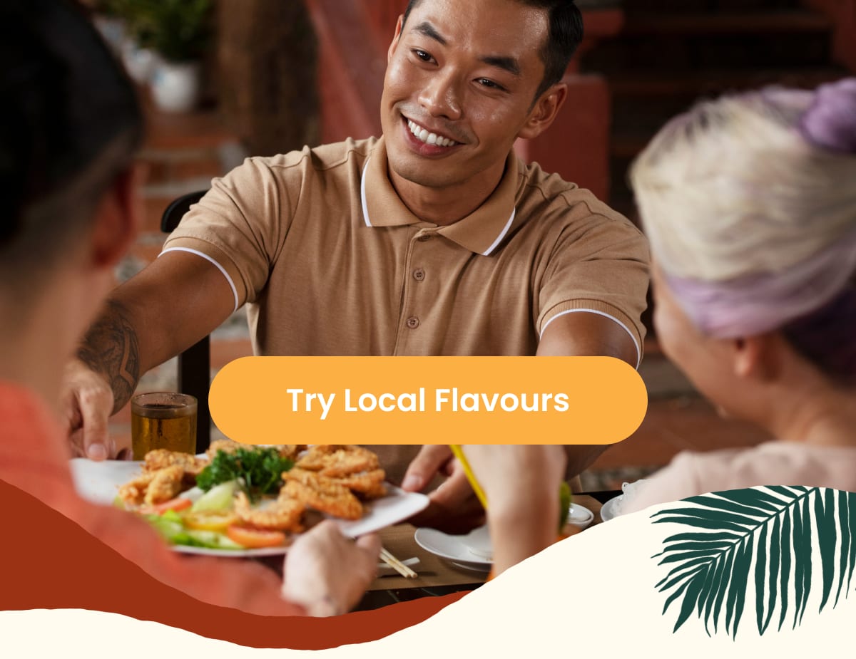 Man serving a plate of fried food to friends in a restaurant with Try Local Flavours button