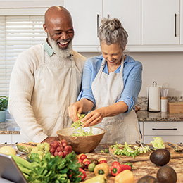 senior adults cooking a meal together