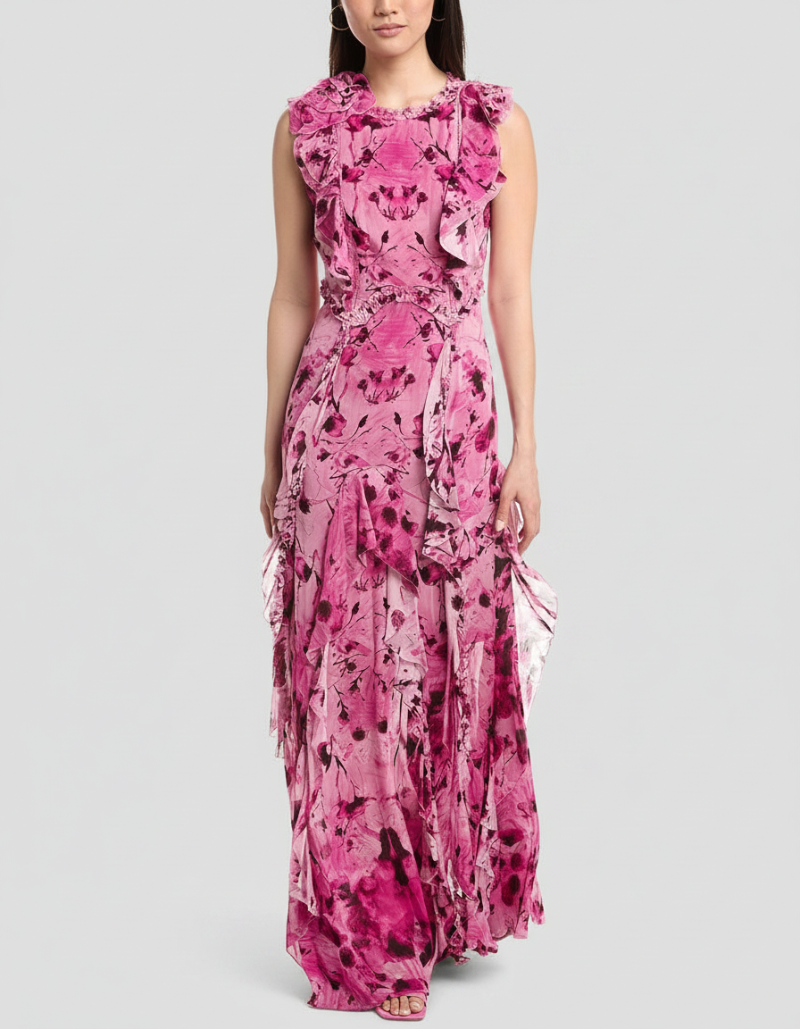 Woman in a flowing pink floral maxi dress with ruffles.