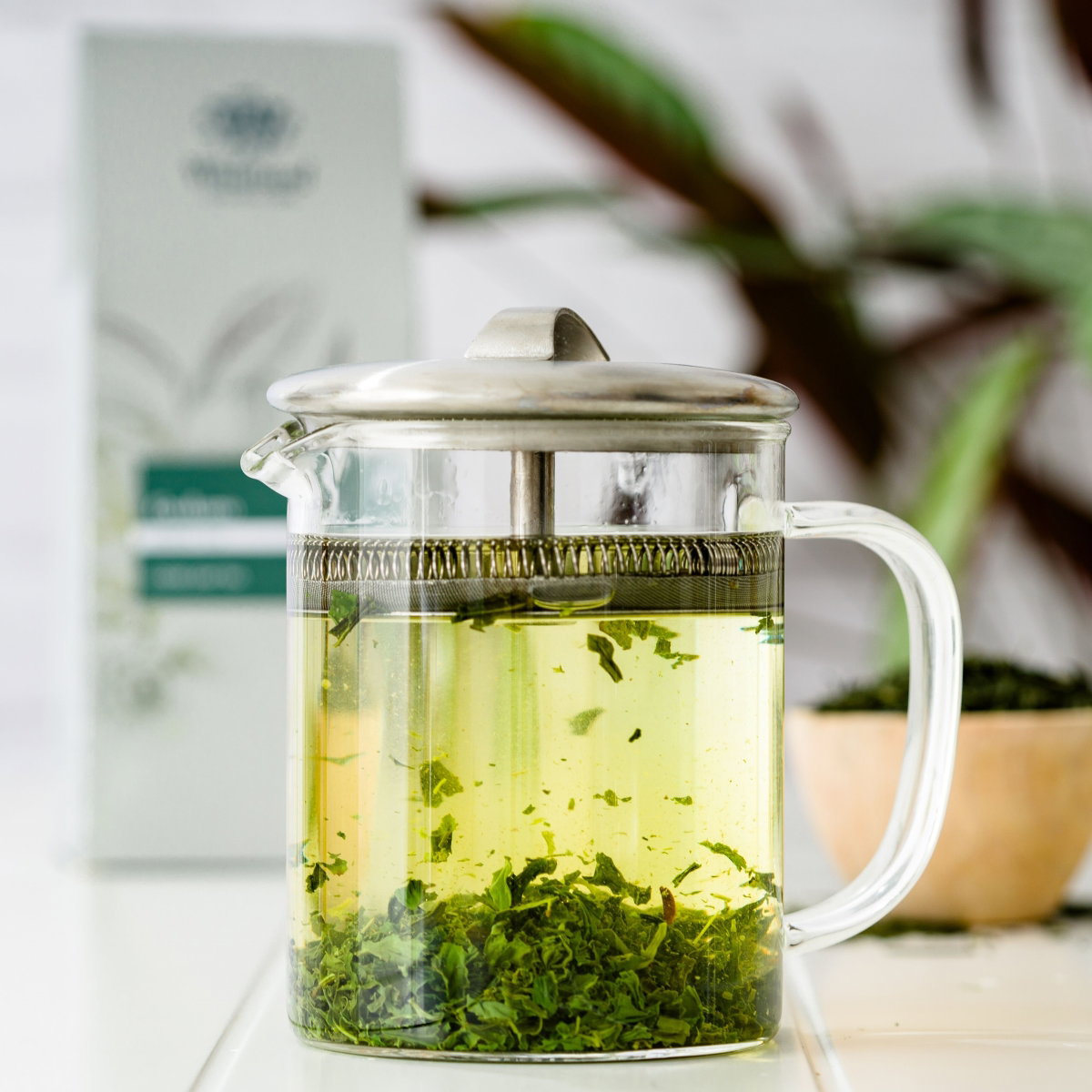 image of gyokuro green tea made up in an infuser with pouch behind