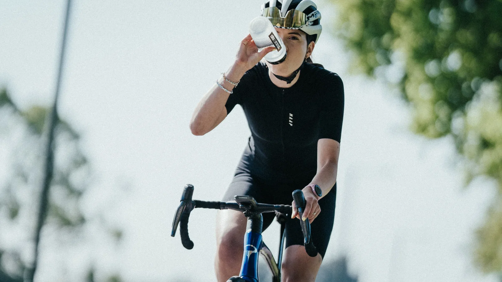 Cyclist drinking in sun