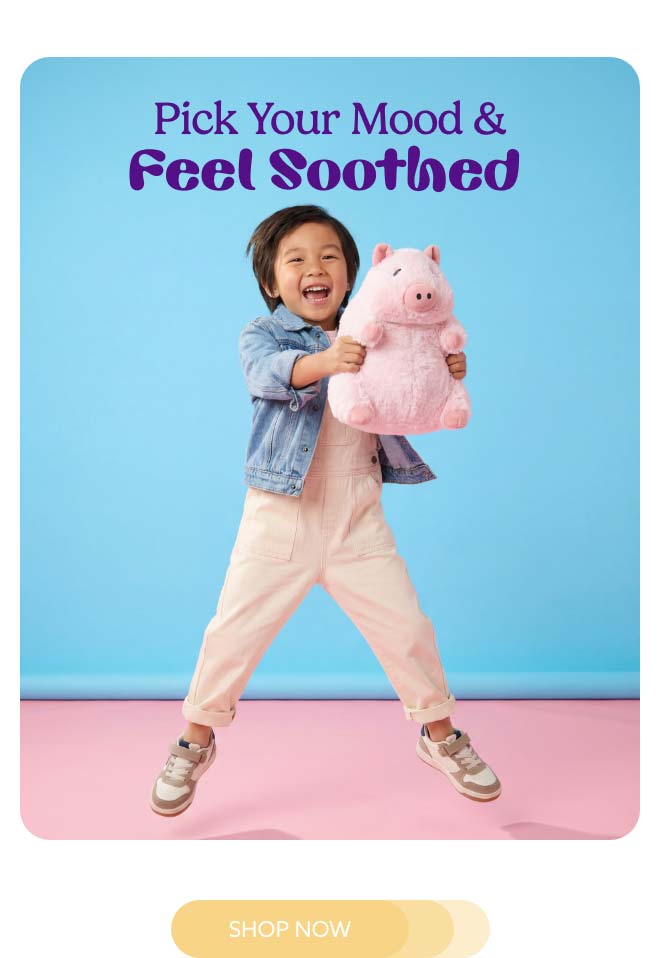 A littly boy jumping with Prosperity Pig Warmies.