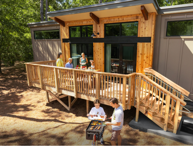 A family outside barbecuing at The Cabins at Disney's Fort Wilderness Resort.