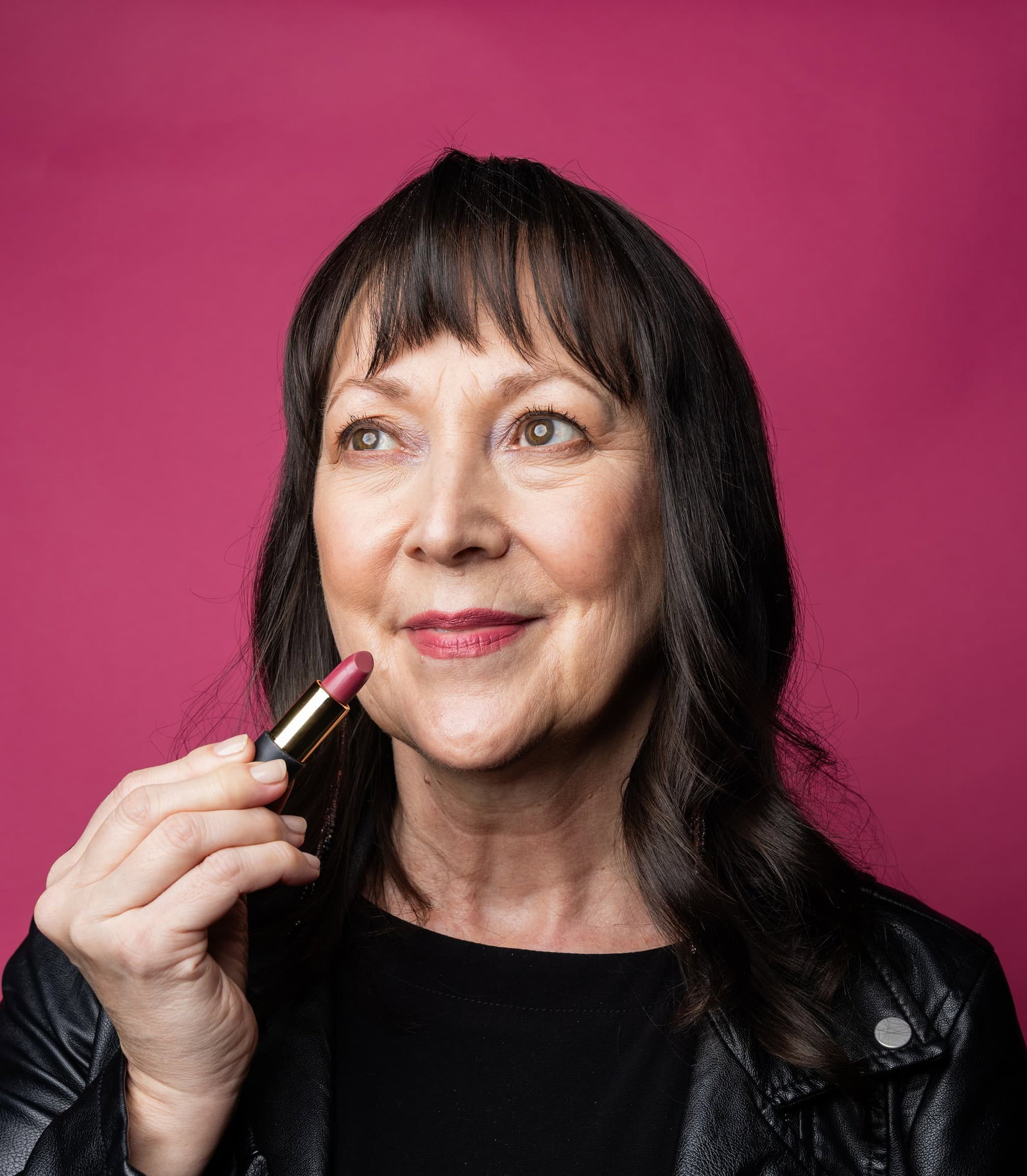 woman holding our new lipstick