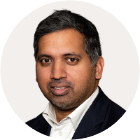 Economics editor Faisal Islam has short dark hair and wears a black blazer and white shirt.