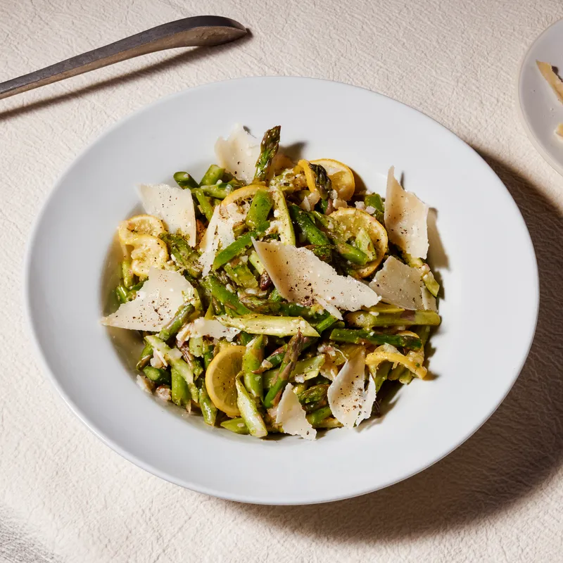 Smashed Asparagus salad on a white plate 