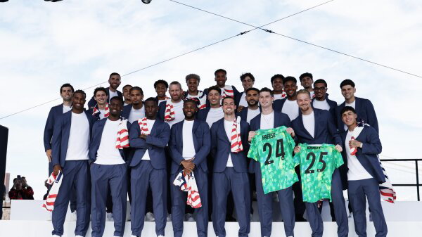 Players of the United States pose for a team photo on stage during the U.S. Soccer World Cup roster announcement.