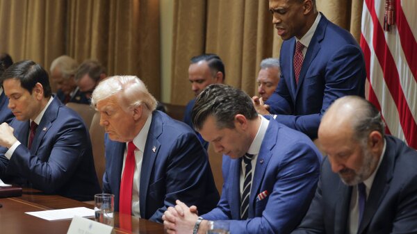 Housing and Urban Development Secretary Scott Turner prays during a Cabinet meeting with President Donald Trump at the White House as Secretary of State Marco Rubio and Defense Secretary Pete Hegseth bow their heads.