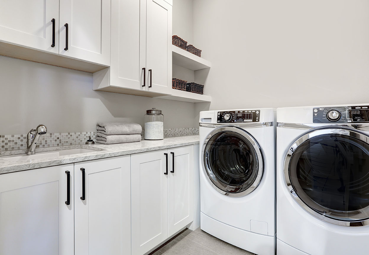 Clean laundry room with a front load washer and dryer