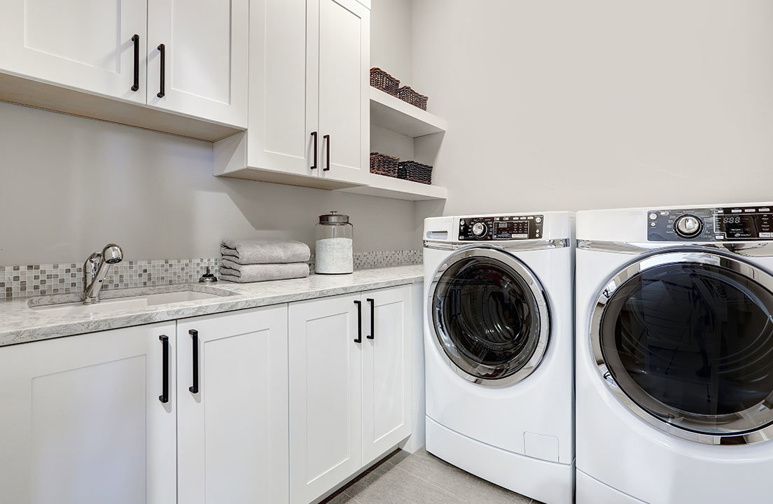 Clean laundry room with a front load washer and dryer