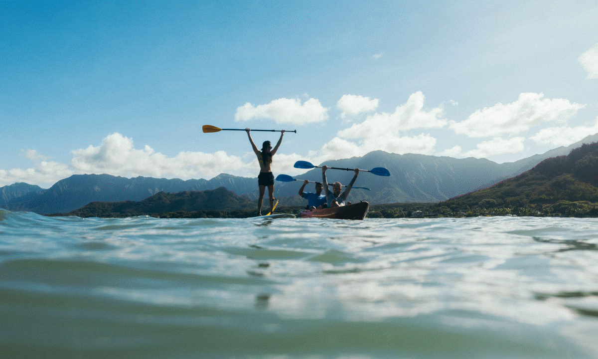 GIF: Couple on a kayak on a sunny day and jumping in the water.