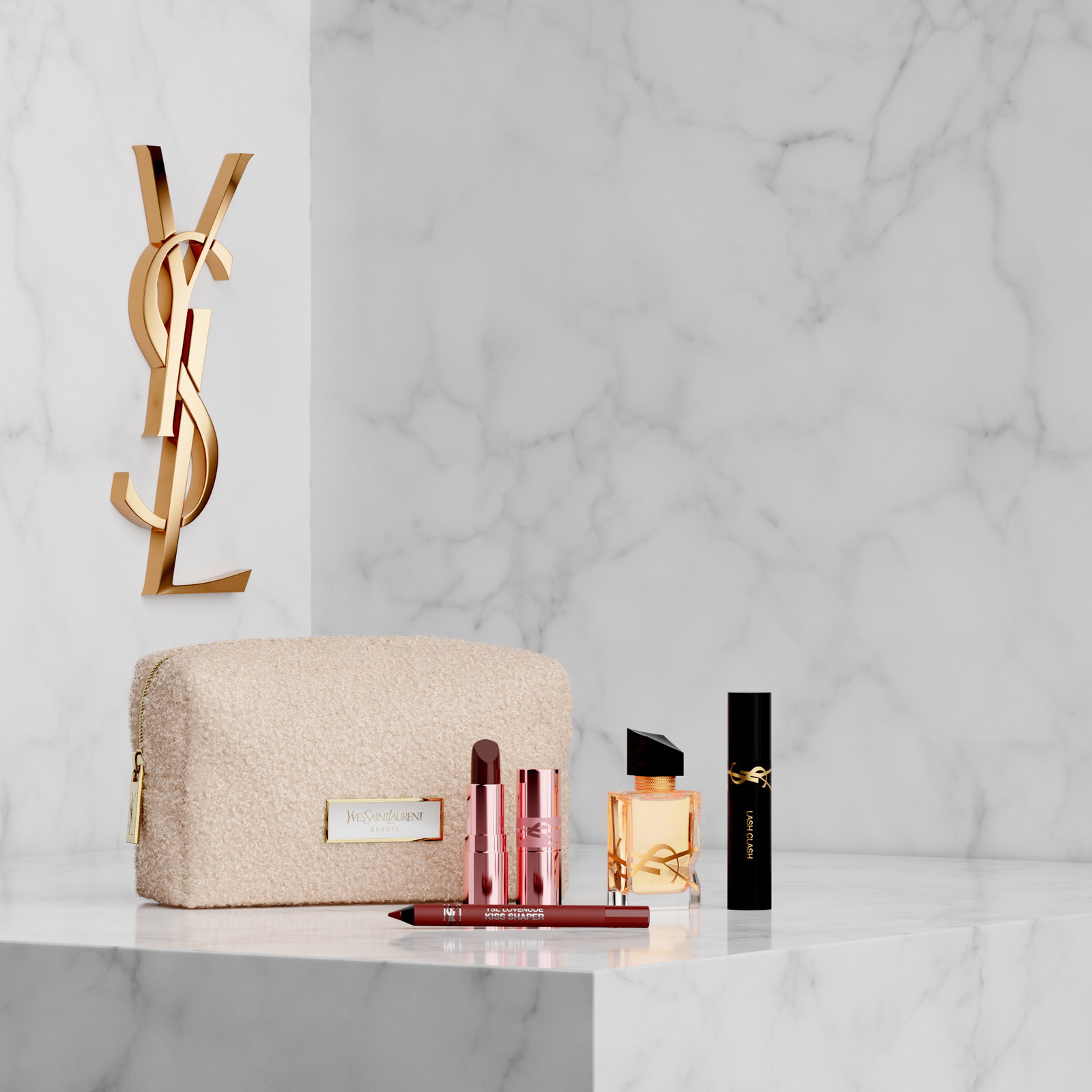 YSL makeup and Libre perfume with a fuzzy beige bag on white marble.