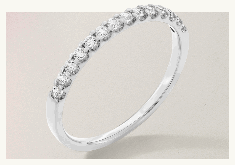 Silver-set ring with circle-cut shaped diamonds wrapped across top half of band.