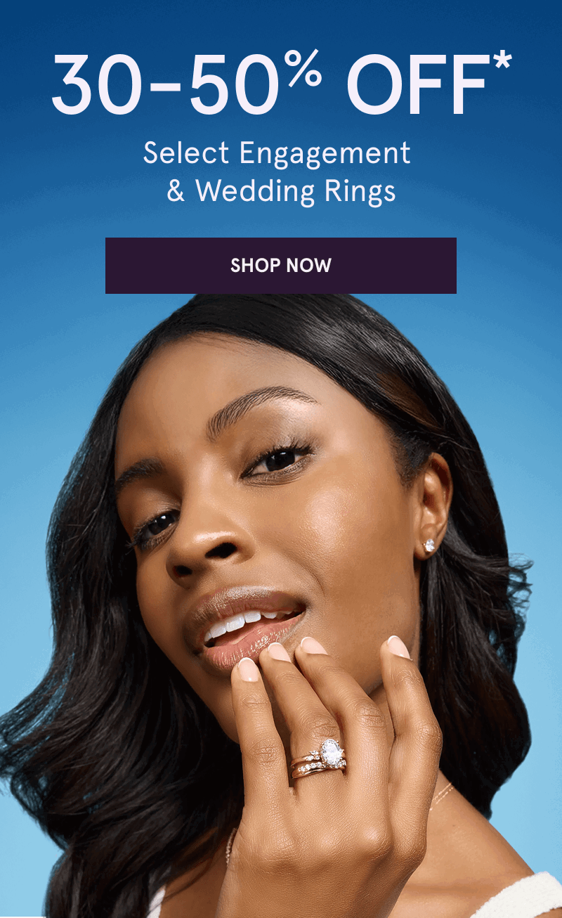Model wearing oval-cut diamond ring with eternity band & matching studs. 30-50% OFF Select Engagement & Wedding Rings. Click here to shop now
