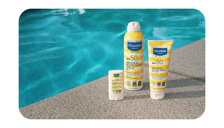 Mustela sunscreen set by a swimming pool