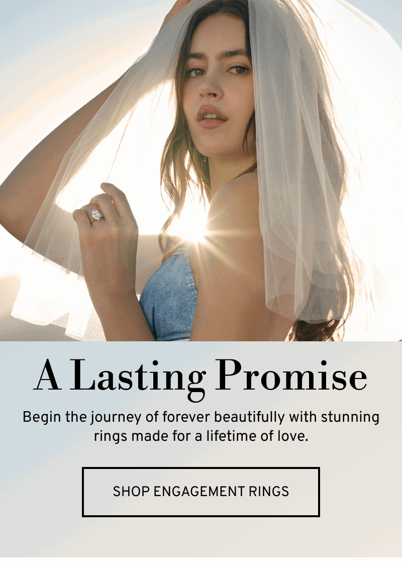 Model wearing a veil and diamond ring. A Lasting Promise. Begin the journey of forever. Click to Shop Engagement Rings