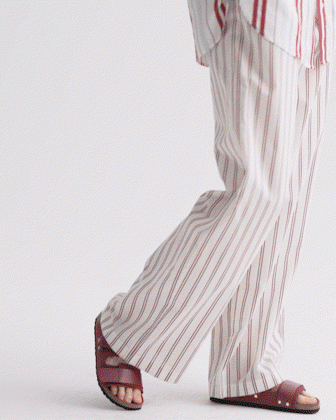 GIF of a model in a striped outfit.