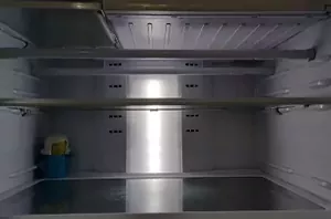 The brilliant reason she hangs 2 small tension rods along the top of her fridge