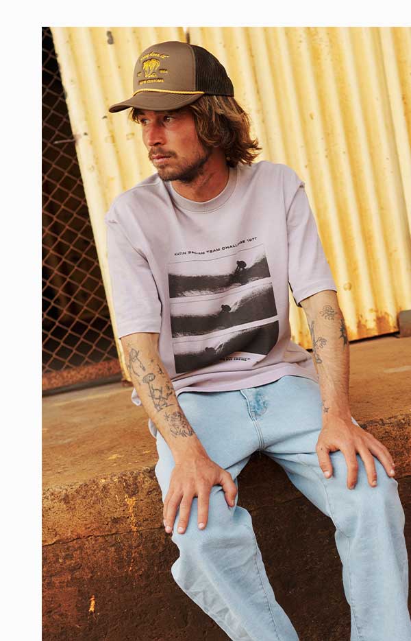 Male model sitting in our Tunnels Box Fit Tee