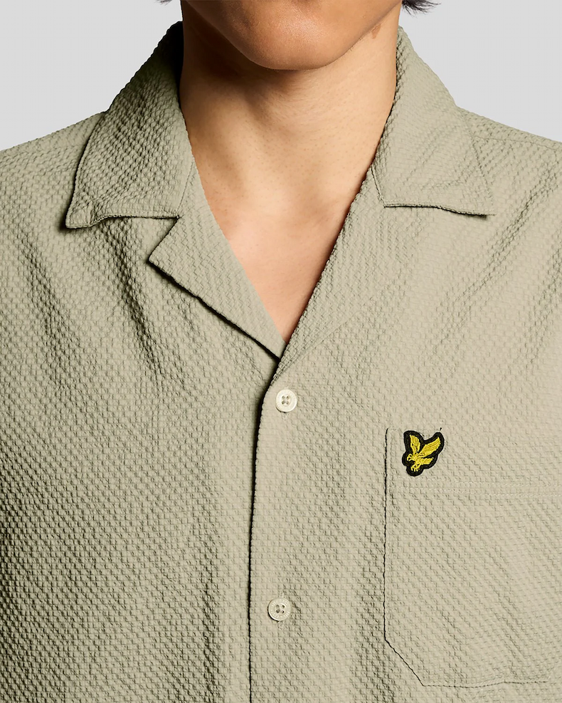 Man wears Short Sleeve Crinkle Resort Shirt in Savona Clay