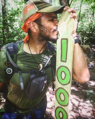 Man kissing trail sign on Appalachian Trail