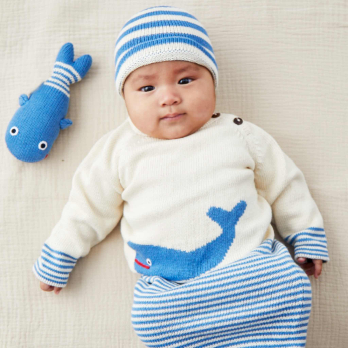 Baby wearing the Whale Romper, Hat & Rattle Set by Estella
