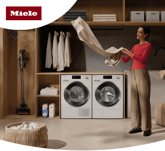 Two Miele washing machines in a laundry room 